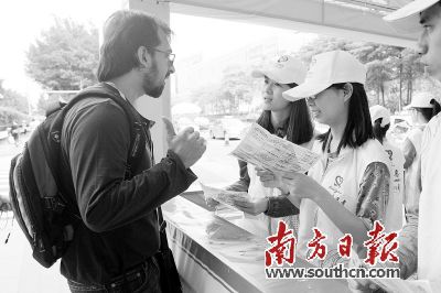 18日，在广交会展馆外，一名外国客商为志愿者的服务点赞。南方日报记者